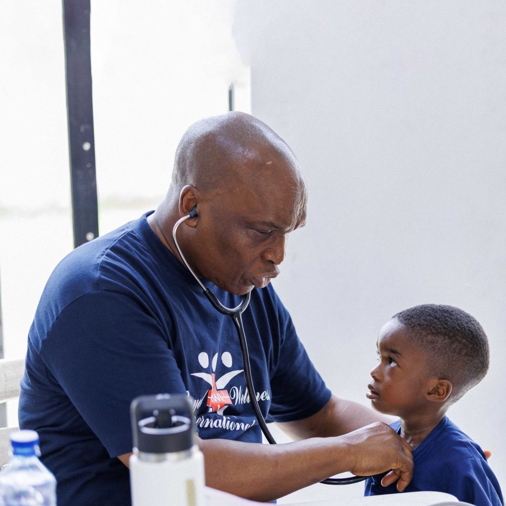 A volunteer counsels a patient during a medical mission